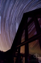 Stars Swirling Above the Cabin star trail photo over Look Out Lodge Kentucky by Dan Bourque